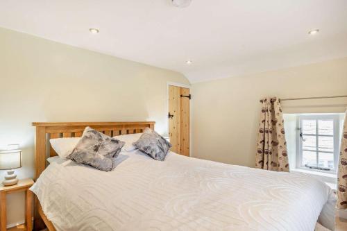 a bedroom with a bed with two pillows on it at 1 Bed in Warslow oc-h27591 in Warslow