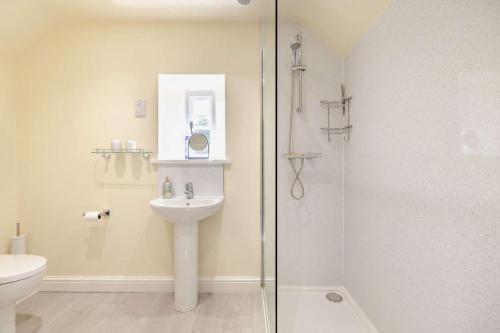 a bathroom with a sink and a glass shower at 1 Bed in Warslow oc-h27591 in Warslow