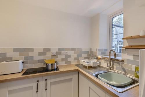 a kitchen with a sink and a window at 2 Bed in Langthwaite oc-c30568 in Low Eskcleth