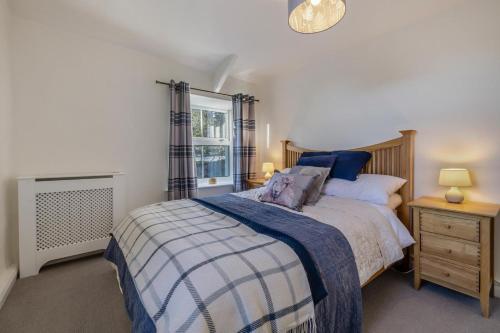 a bedroom with a large bed and a window at 2 Bed in Langthwaite oc-c30568 in Low Eskcleth