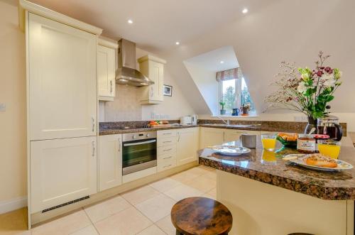 a kitchen with white cabinets and a counter top at 1 Bed in Woodstock oc-u30547 in Kidlington