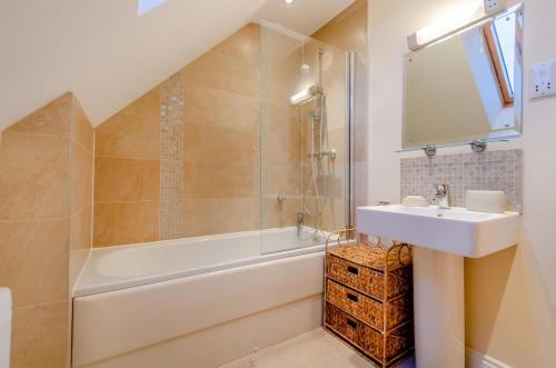 a bathroom with a sink and a shower and a tub at 1 Bed in Woodstock oc-u30547 in Kidlington