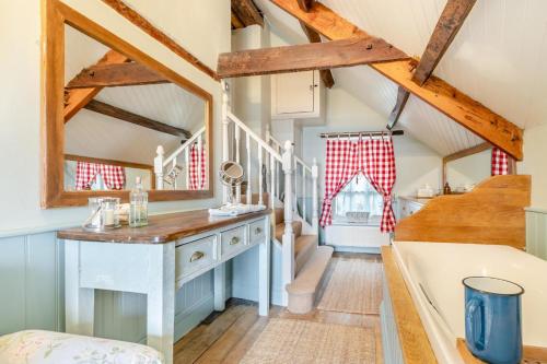 a kitchen with a desk in a room with wooden beams at 6 Bed in Llanfilo oc-e30630 in Llandefalle