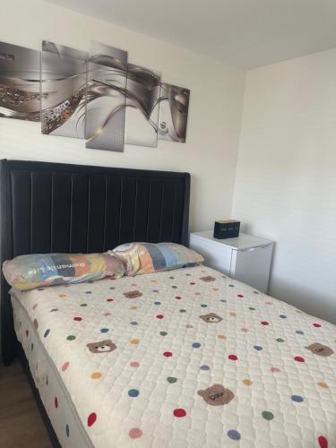 a bedroom with a bed with a comforter on it at Precious Home in Monasterevin