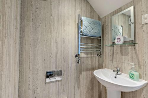 a bathroom with a sink and a mirror at 3 Bed in Ilfracombe oc-s29585 in Ilfracombe