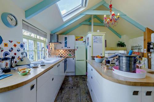a kitchen with white cabinets and a blue ceiling at 1 Bed in St. Ives oc-e28023 in St Ives