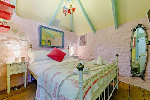 a pink bedroom with a bed and a mirror at 1 Bed in St. Ives oc-e28023 in St Ives