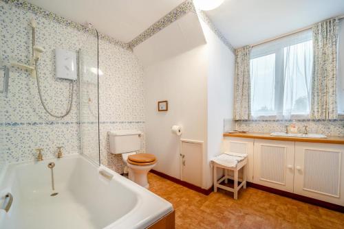 a bathroom with a tub and a toilet and a sink at 3 Bed in North Connel oc-a29963 in Connel