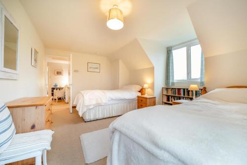a bedroom with two beds and a desk and a table at 3 Bed in North Connel oc-a29963 in Connel