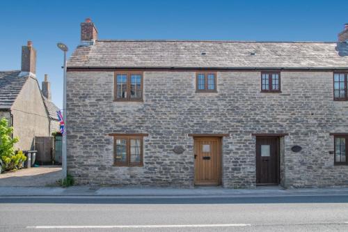 a brick house with two doors on a street at 2 Bed in Corfe Castle oc-a30970 in Corfe Castle