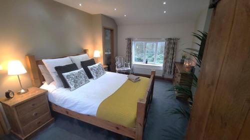 a bedroom with a large bed and a window at 4 Bed in Little Hayfield oc-c31097 in Hayfield