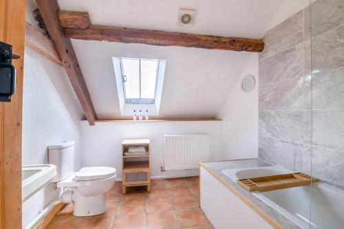 a bathroom with a toilet and a sink and a bath tub at 3 Bed in Llanvetherine oc-g31918 in Llanvetherine