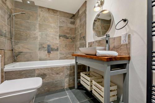 a bathroom with a sink and a tub at 5 Bed in St. Issey oc-r4328 in Saint Issey