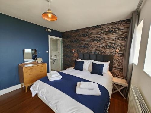 a bedroom with a large bed with towels on it at 2 Bed in Craster oc-c25099 in Craster