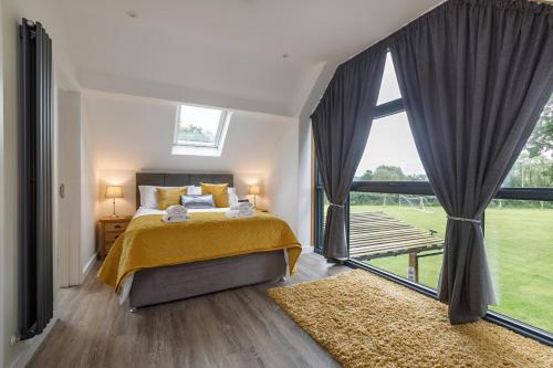 a bedroom with a bed and a large window at 4 Bed in Saham Toney oc-o30348 in Saham Toney
