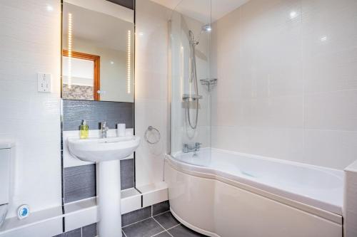 a bathroom with a sink and a shower and a tub at 1 Bed in Crakehall oc-o30357 in Crakehall