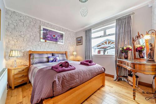 a bedroom with a large bed and a piano at 4 Bed in Lochgoilhead oc-j30107 in Carrick