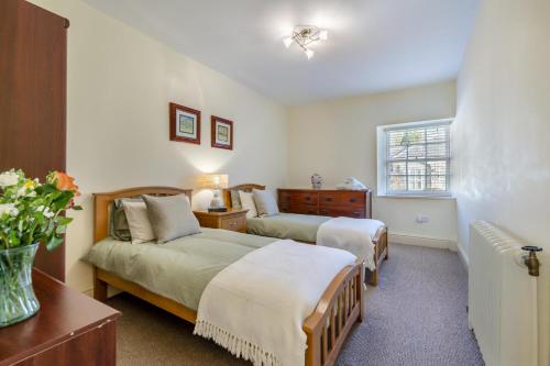 a bedroom with two beds and a window at 2 Bed in Cornhill-on-Tweed oc-d30765 in Cornhill-on-tweed