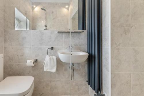 a bathroom with a white sink and a toilet at 2 Bed in Cornhill-on-Tweed oc-d30765 in Cornhill-on-tweed
