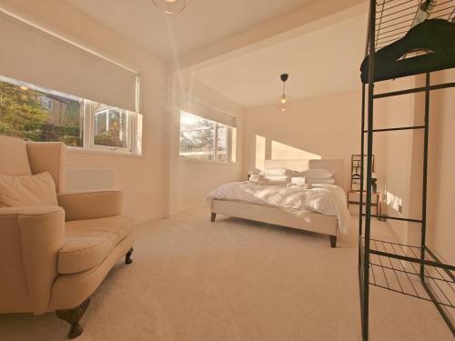a bedroom with a bed and a couch and a chair at 5 Bed in Tealby oc-t30618 in Tealby