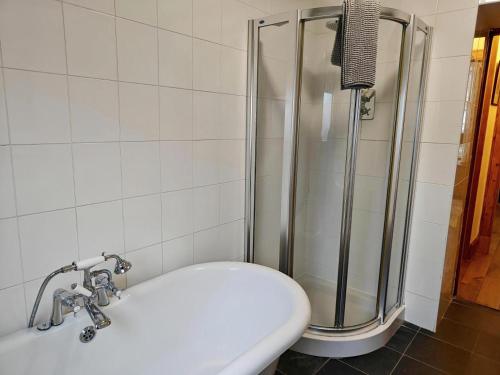 a bathroom with a shower and a white toilet at 3 Bed in Aviemore oc-s30815 in Aviemore