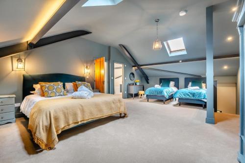 a bedroom with two beds with blue walls at 4 Bed in Ewhurst Green oc-w31032 in Hurst Green