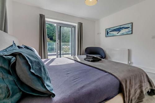 a bedroom with a large bed and a window at 4 Bed in Wadebridge oc-l30127 in Wadebridge