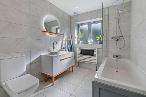 a bathroom with a sink and a toilet and a tub at 4 Bed in Wadebridge oc-l30127 in Wadebridge
