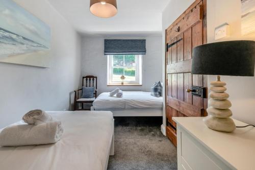 a bedroom with a bed and a table with a lamp at 4 Bed in St. Brides oc-o30488 in Saint Brides