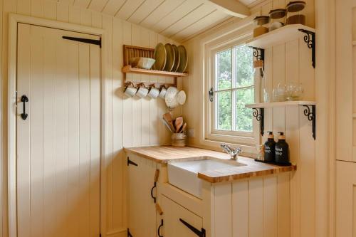 a small kitchen with a sink and a window at 1 Bed in Burnham Overy Town oc-o31908 in Burnham Market