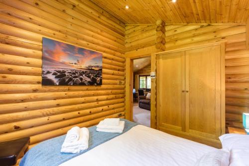 a bedroom with a bed in a log cabin at 2 Bed in Felton oc-c30643 in Felton