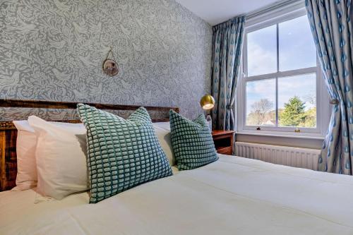 a bedroom with a bed with blue and white pillows at 3 Bed in Goathland oc-p30205 in Goathland