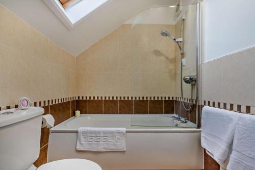 a bathroom with a bath tub and a toilet at 3 Bed in Goathland oc-p30205 in Goathland
