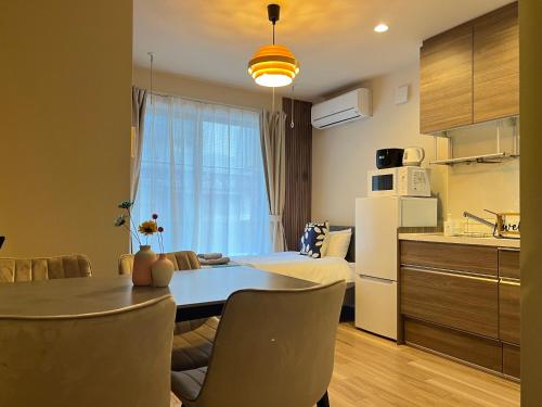 a kitchen and dining room with a table and chairs at nestay apartment tokyo sumida in Tokyo
