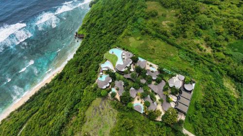 an aerial view of a group of houses next to the ocean at Nya Uluwatu in Uluwatu