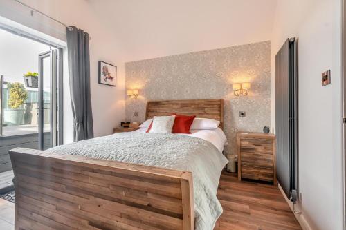 a bedroom with a large bed with a wooden headboard at 1 Bed in Hunmanby oc-w30527 in Hunmanby
