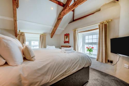 a bedroom with a large bed with a flat screen tv at 3 Bed in Egloshayle oc-m32201 in Egloshayle