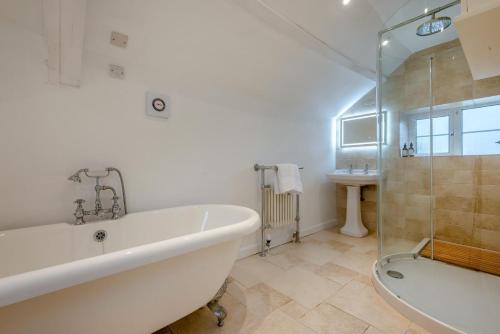 a bathroom with a bath tub and a sink at 3 Bed in Egloshayle oc-m32201 in Egloshayle