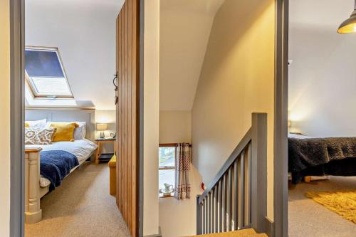 a small bedroom with a bed and a stairway at 2 Bed in Pentre Bach oc-b30875 in Pentre-bâch
