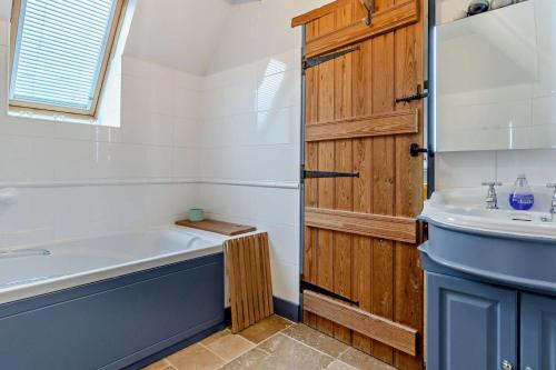 a bathroom with a tub and a sink at 2 Bed in Pentre Bach oc-b30875 in Pentre-bâch