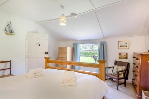 a bedroom with a large white bed and a window at 2 Bed in Stalham oc-u32571 in Stalham