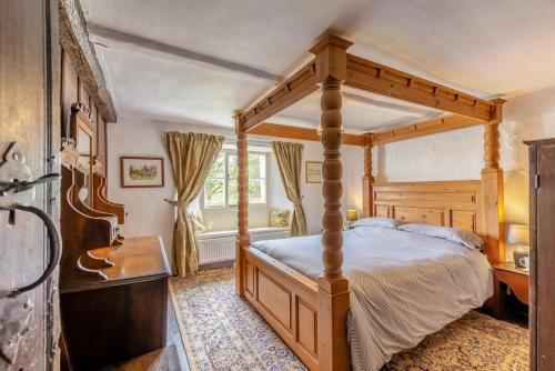 a bedroom with a canopy bed and a desk at 3 Bed in Windermere oc-b31667 in Crook