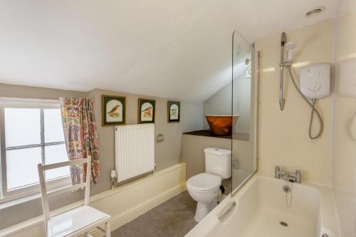 a bathroom with a toilet and a bath tub at 3 Bed in Windermere oc-b31667 in Crook