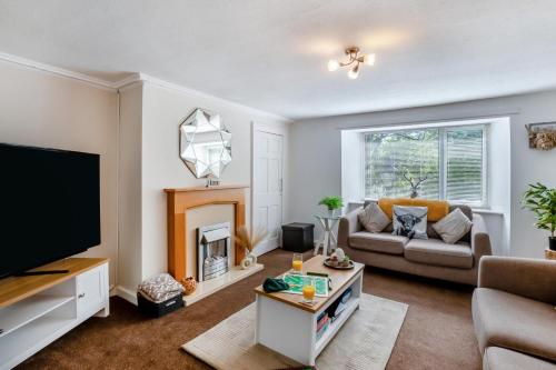 a living room with a couch and a fireplace at 2 Bed in Rothbury oc-e31872 in Rothbury