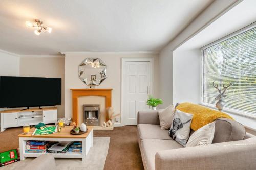a living room with a couch and a flat screen tv at 2 Bed in Rothbury oc-e31872 in Rothbury