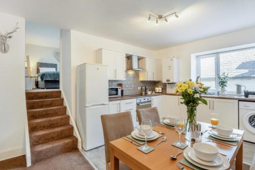 a kitchen with a wooden table with chairs and a dining room at 2 Bed in Rothbury oc-e31872 in Rothbury