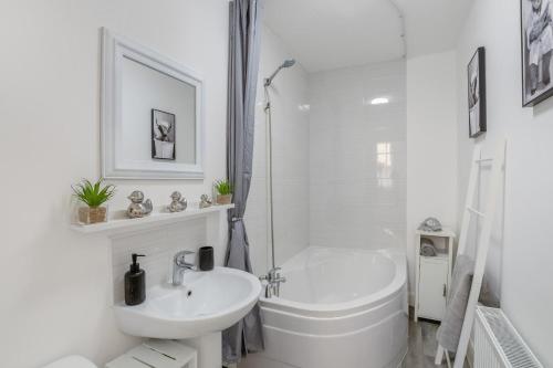 a white bathroom with a tub and a sink at 2 Bed in Rothbury oc-e31872 in Rothbury