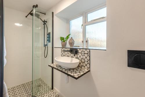 a bathroom with a sink and a glass shower at 3 Bed in Caldbeck oc-h30704 in Caldbeck