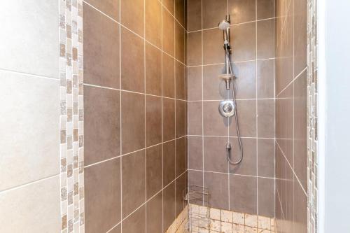 a shower with a shower head in a bathroom at 4 Bed in Caistor oc-t30831 in Caistor