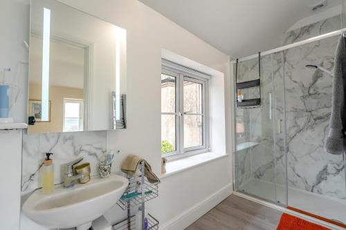 a white bathroom with a sink and a shower at 5 Bed in Battle oc-c31779 in Battle